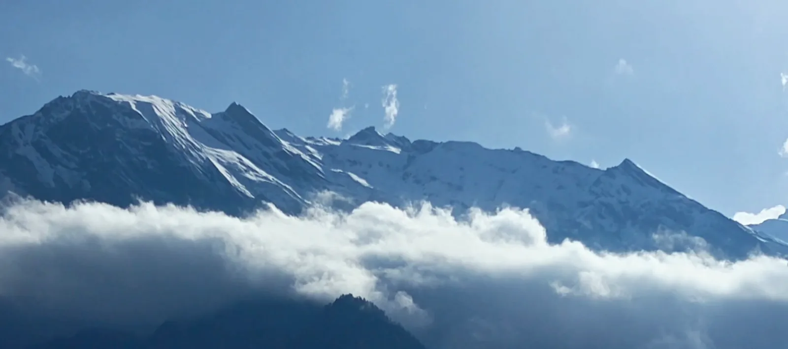 Clouds moving across snow peaks above Harsil Valley